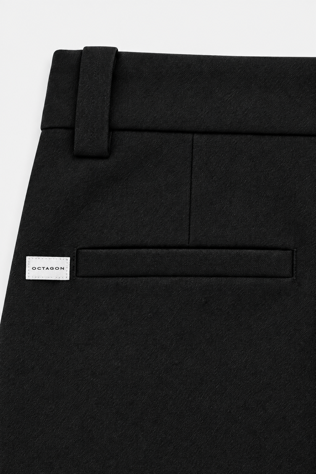 Small woven Octagon label aligned left of the left rear pocket
