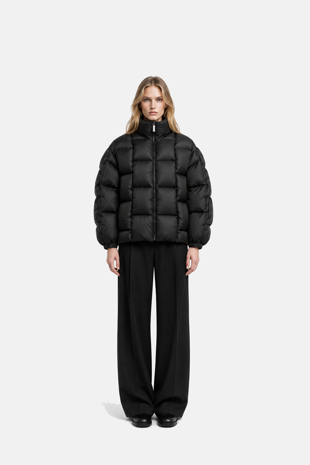 Female model wearing the black OCTAGON Diagram Puffer, full-body front fit view