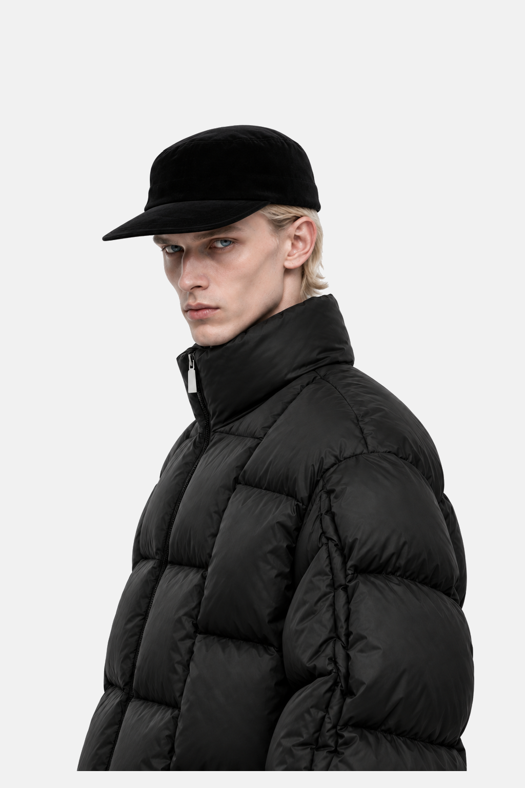 Blond male model wearing the black OCTAGON Diagram Puffer, three-quarter collar and shoulder detail