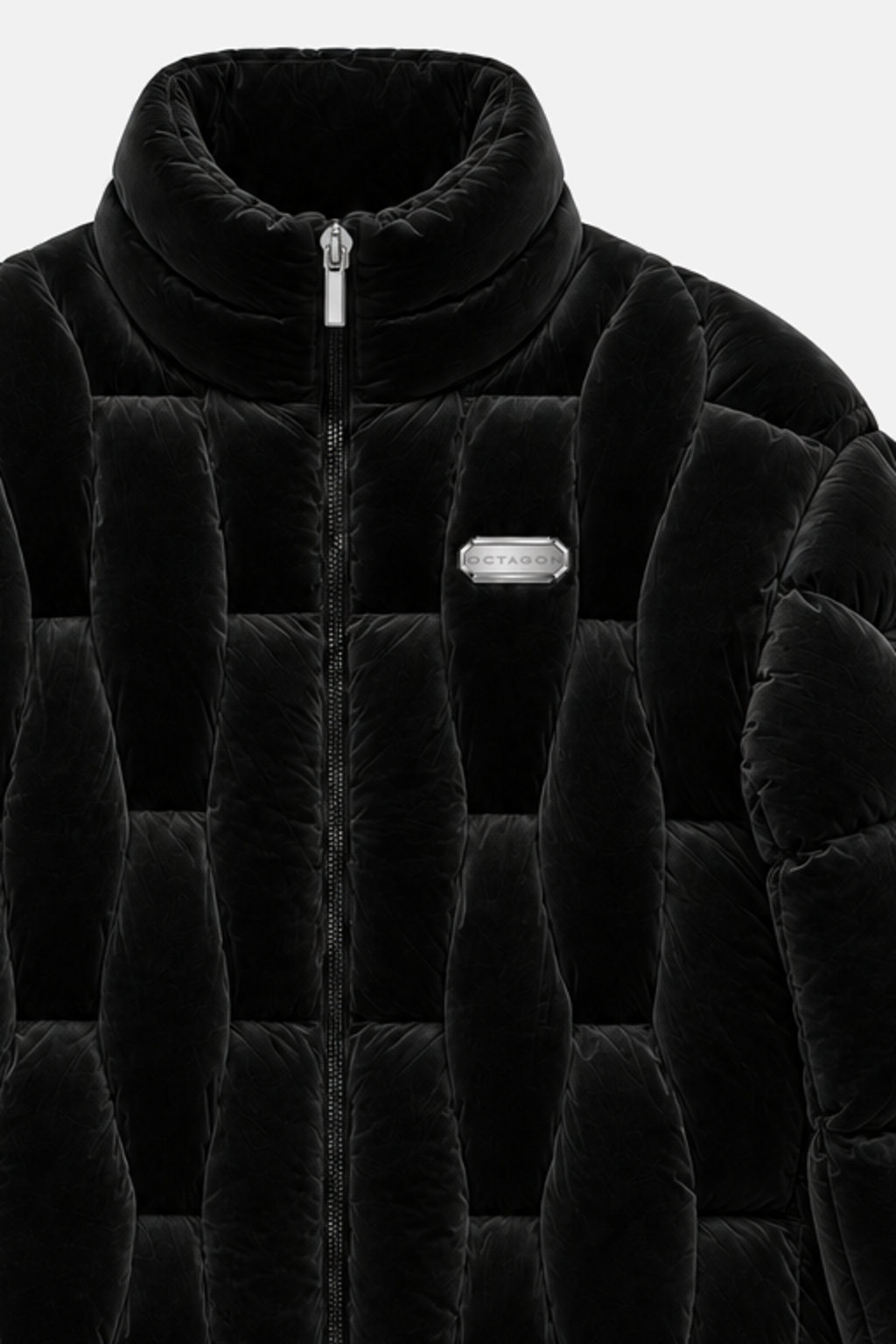 Close detail of the black velvet OCTAGON Pentagon Puffer collar, chrome zipper pull, and stainless badge