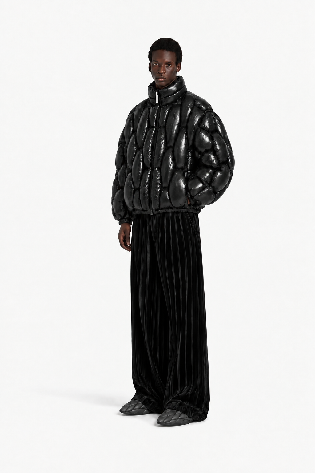 Male model wearing the glossy black OCTAGON Pentagon Puffer in a tag-free front view