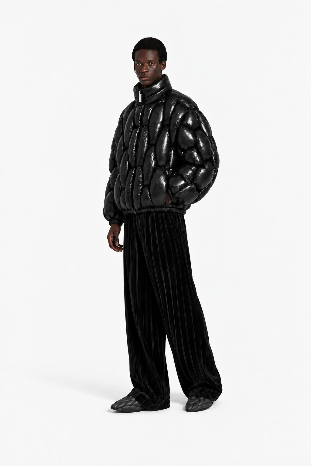 Male model wearing the glossy black OCTAGON Pentagon Puffer in a tag-free three-quarter view