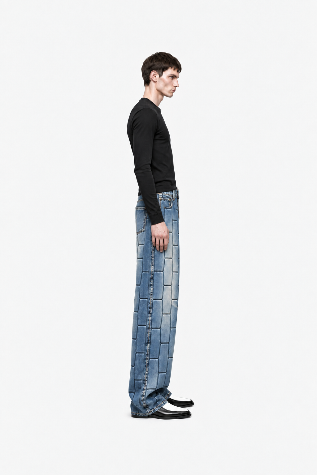 Male model wearing vintage-blue OCTAGON Pentagon debossed jeans, side profile