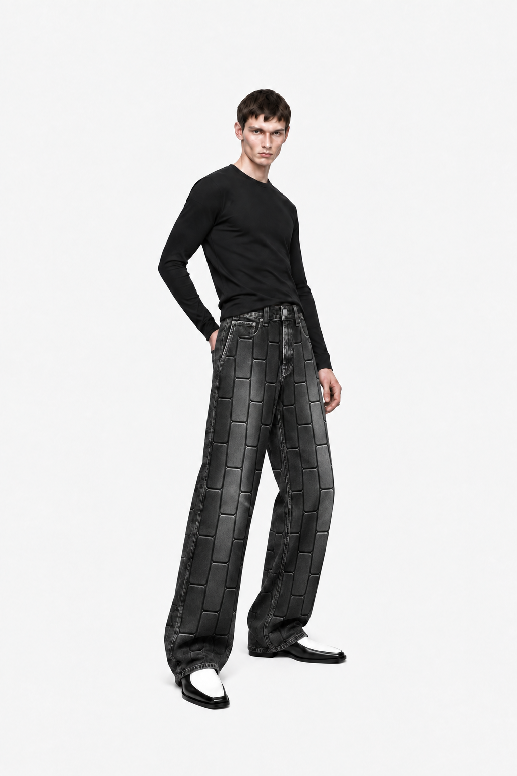 Male model wearing washed-black OCTAGON Pentagon debossed jeans, three-quarter view