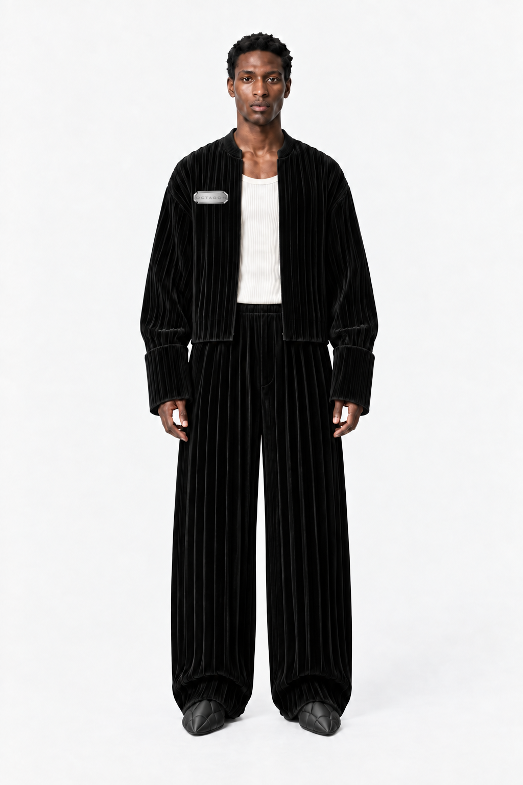 Male model wearing the OCTAGON Folio black pleated velvet jacket